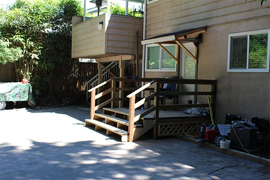 Overhang door contractor in Vancouver installing a custom front entrance canopy